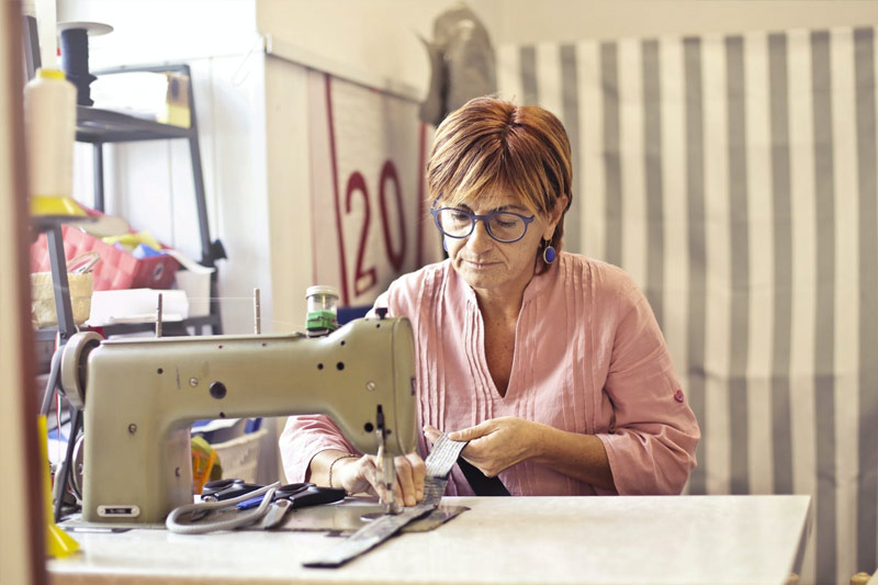 NEIS Program can help woman sewing for her business 